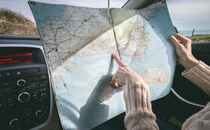 Women holding map in a car