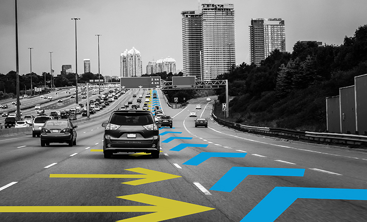 Cars on a motorway with arrows indicating a car lane change.